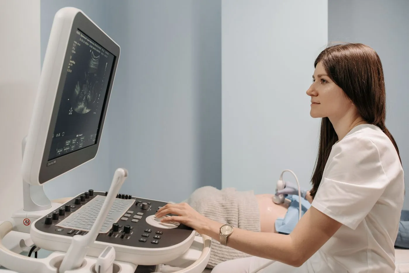 Woman sonologist at the ultrasound machine